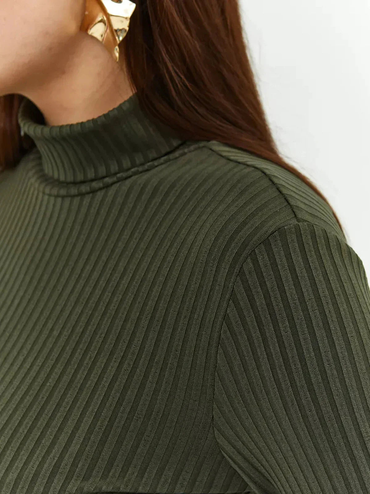 Close-up of the ribbed texture and high neckline of the Olive Curve Midi Dress in olive green.
