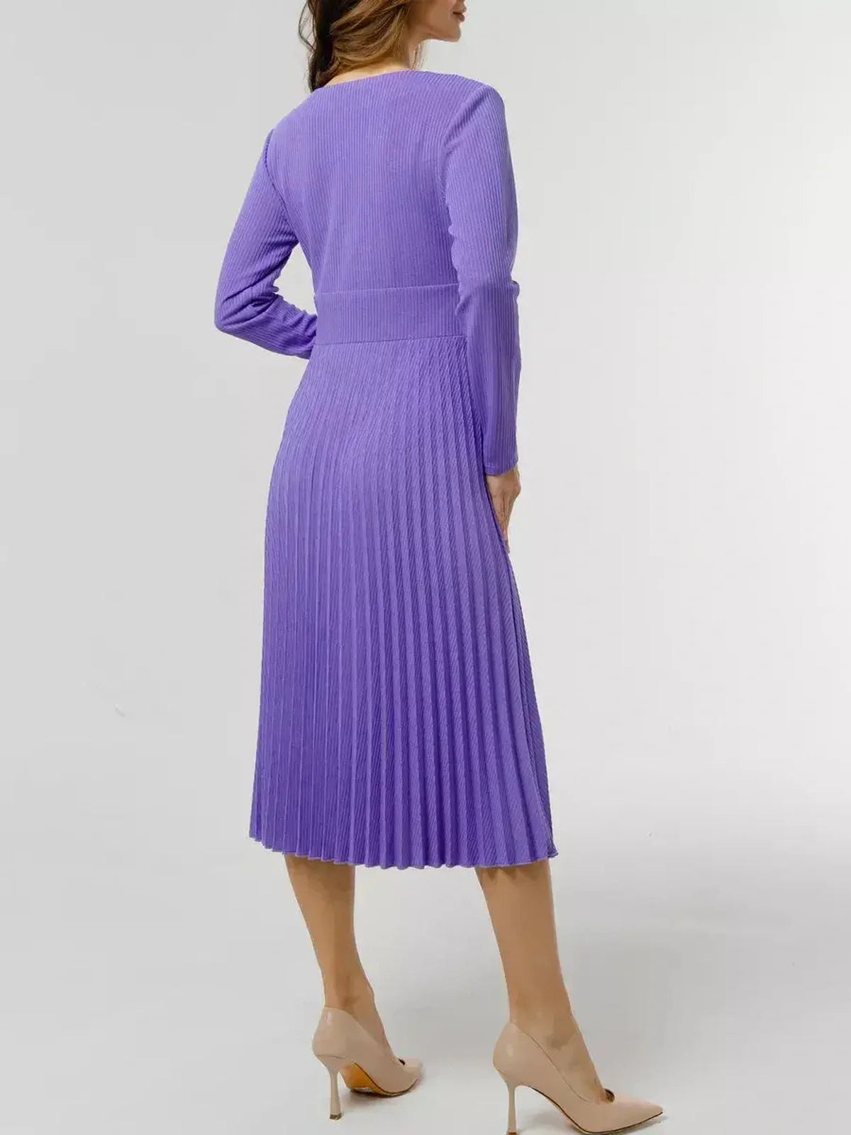 Back view of a woman in a luxe purple pleated midi dress, showcasing elegant long sleeves and flowing skirt.