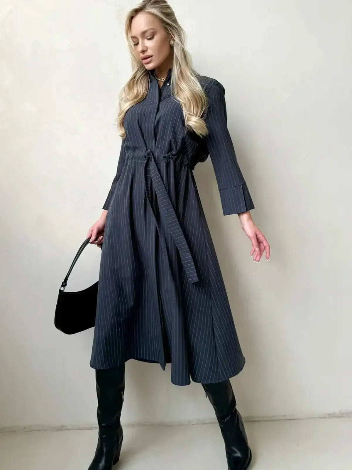 Slate Stripe Midi Dress featuring vertical pinstripes, a structured silhouette, and a soft waist tie, perfect for various occasions.