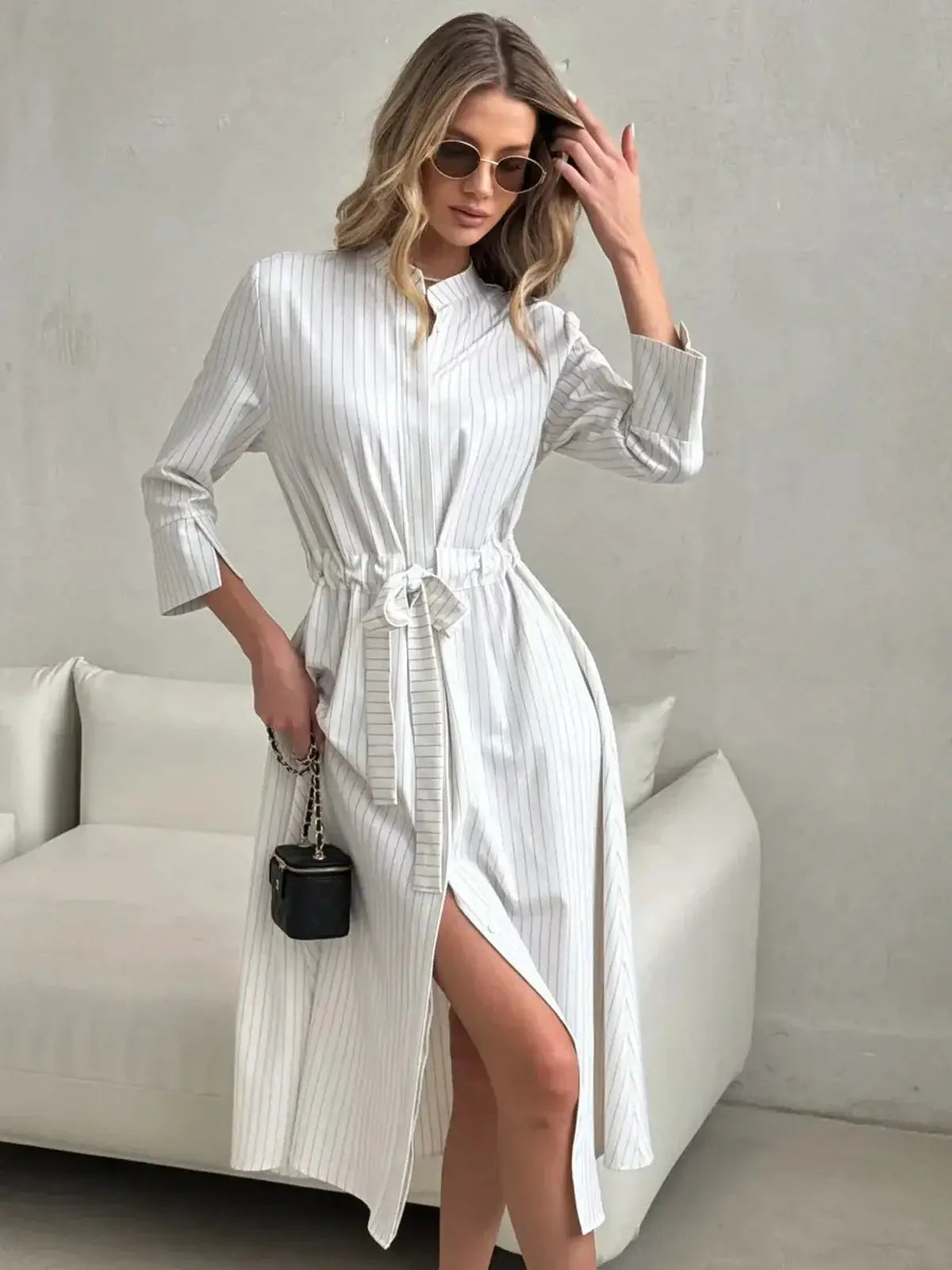 Elegant pinstripe midi dress with waist tie and front slit, perfect for wedding guest and summer occasions.