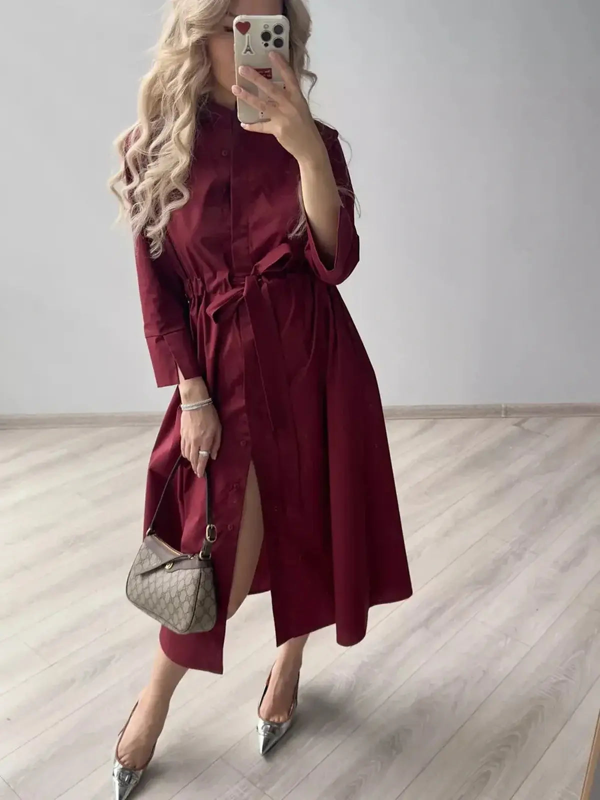 Burgundy Grace Midi Dress featuring a fitted waist and A-line silhouette, styled for elegant occasions.