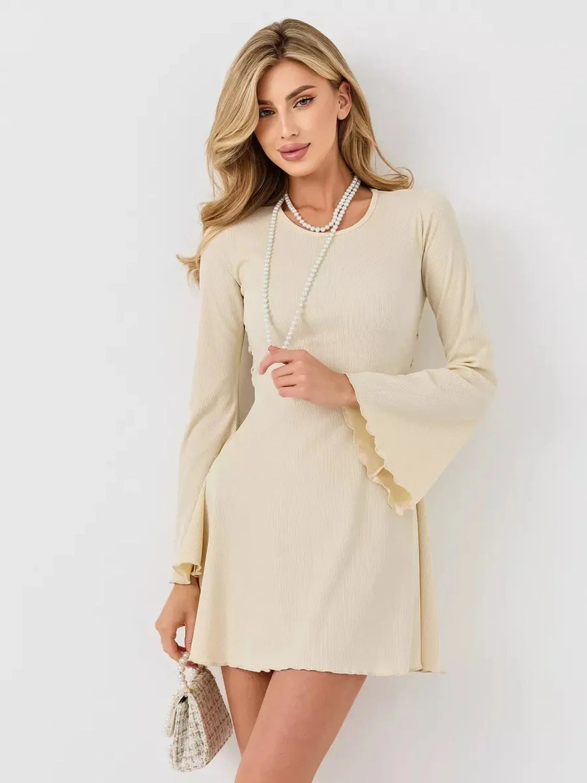 Ivory Flare mini dress with long bell sleeves and ribbed texture, perfect for weddings and special occasions.