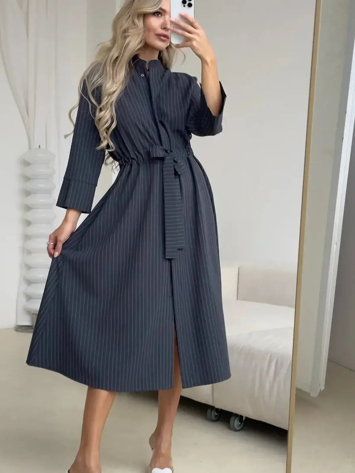 Elegant slate stripe midi dress with a relaxed fit, featuring a waist tie for versatile day-to-evening styling.