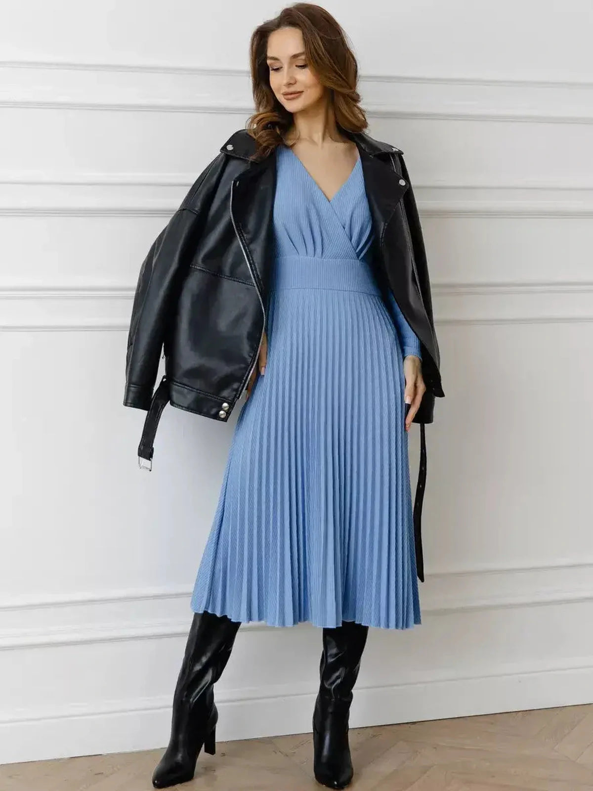 Celeste Midi Dress in sky blue with pleats, paired with a black leather jacket and knee-high boots.