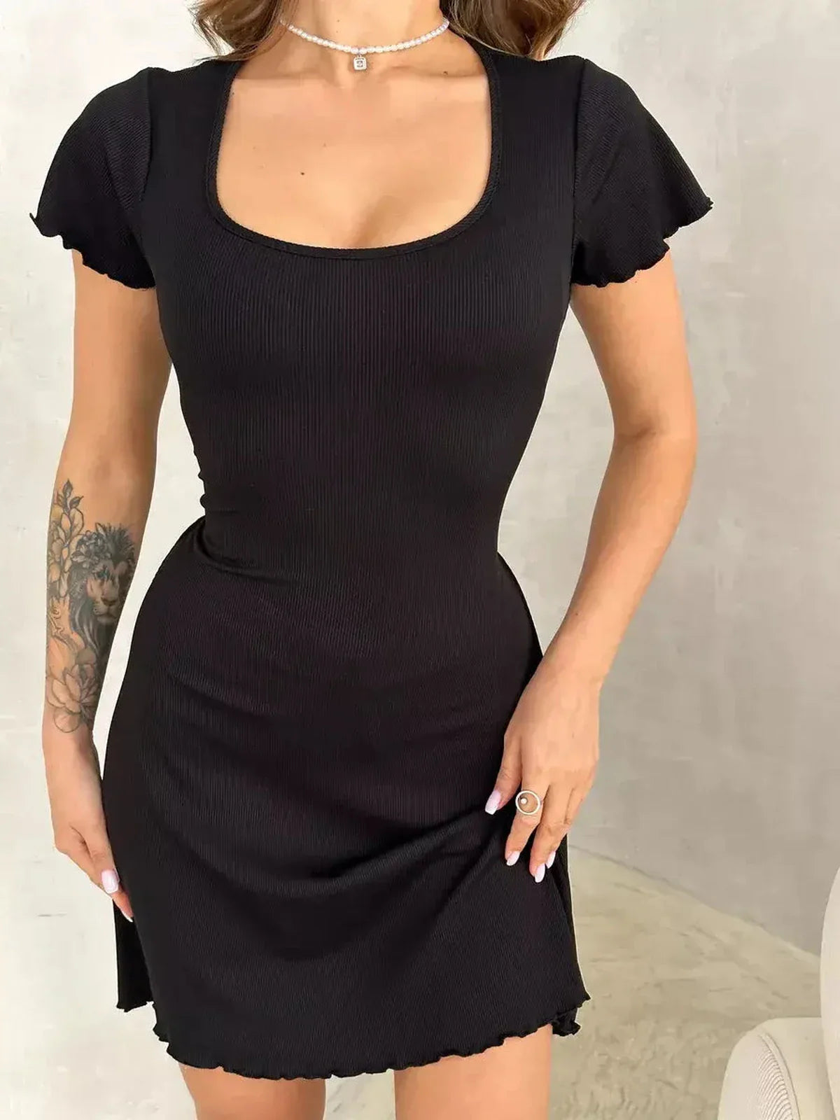 Black Laced Icon Mini Dress featuring a sculpted fit and chic silhouette, perfect for summer soirées and cocktail events.