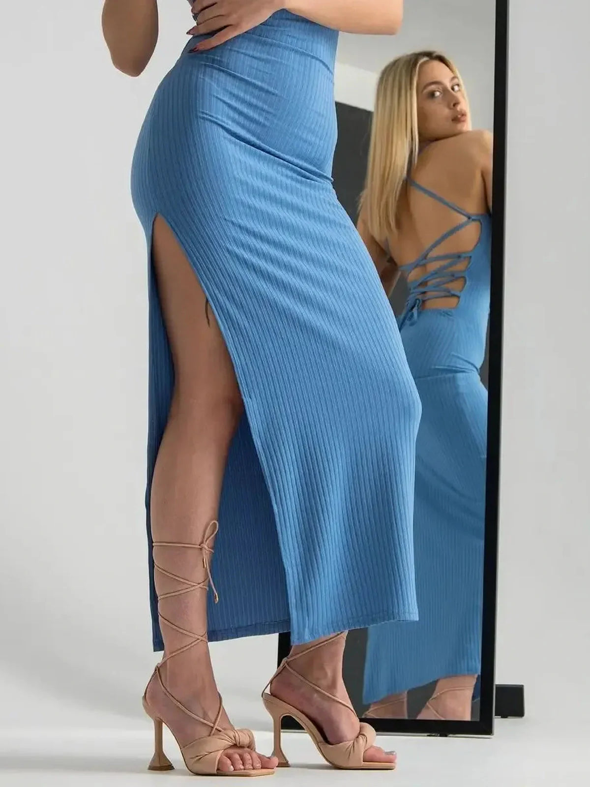 Model wearing the Ocean Lace Midi Dress, showcasing a side slit and corset back, perfect for summer occasions.