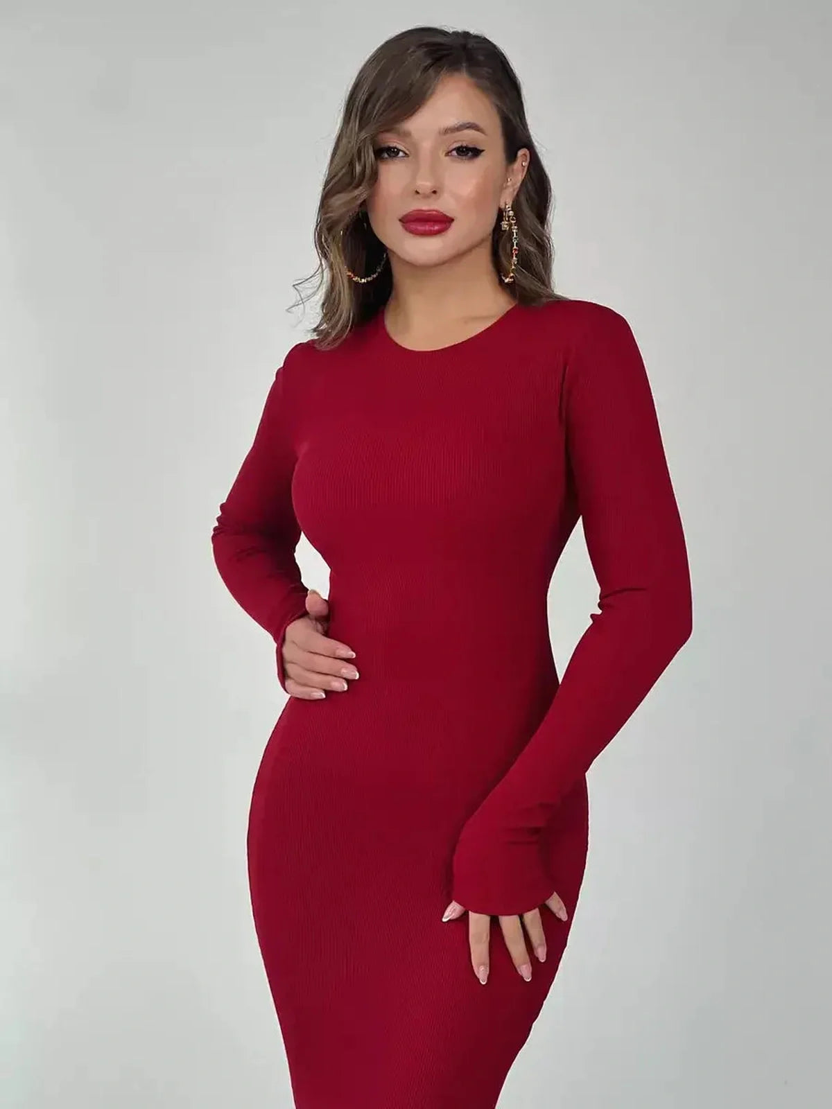 Elegant red Velvet Ember maxi dress with long sleeves, showcasing a sleek, figure-hugging silhouette for women.