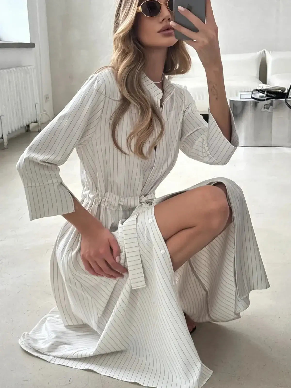 Pinstripe midi dress with a cinched waist and mandarin collar, perfect for casual or formal occasions.