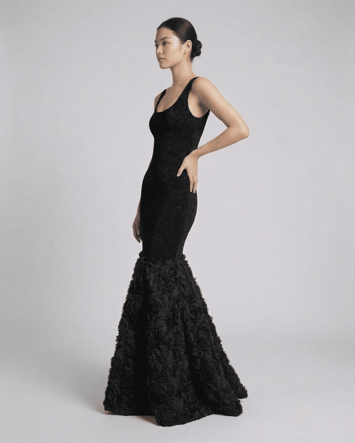 Nocturne Maxi Dress by Slimona, showcasing an elegant black sculpted silhouette with textured hem detail.