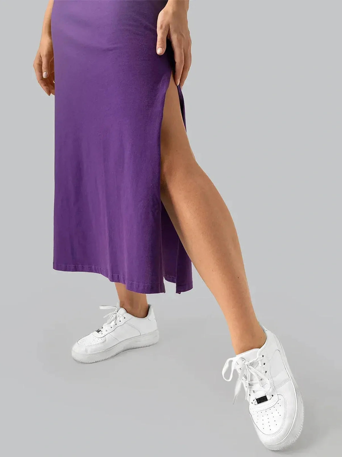 Close-up of a purple side slit midi dress paired with white sneakers, showcasing its casual-chic style.