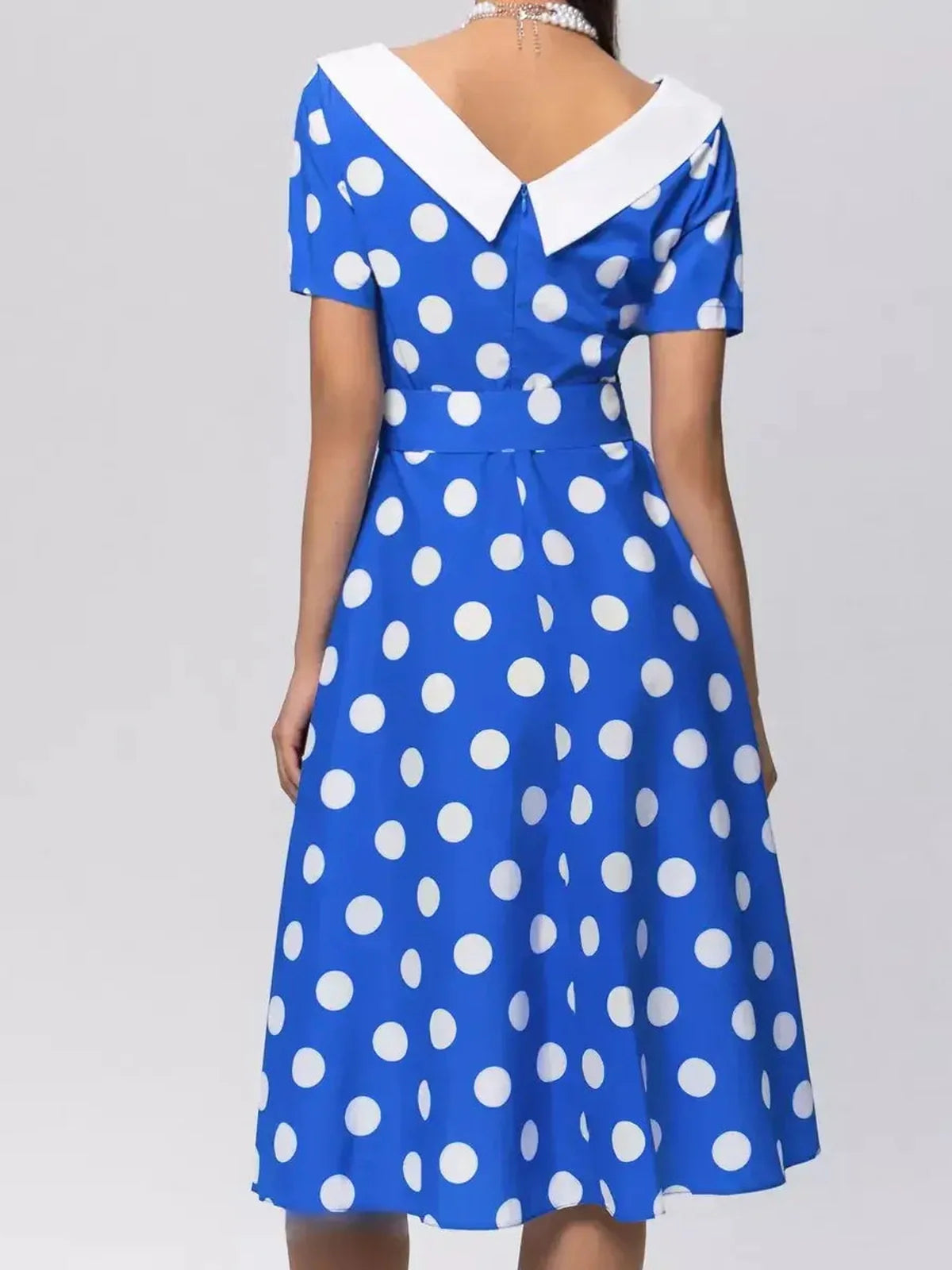 Back view of Midi Dress Azure Dots featuring white polka dots and a crisp white collar, perfect for summer wear.
