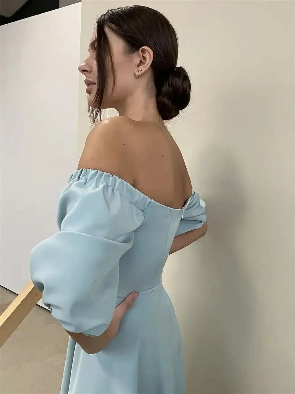 Off-shoulder Serenity Midi Dress showcasing a mint-blue hue and voluminous sleeves, perfect for weddings and special occasions.