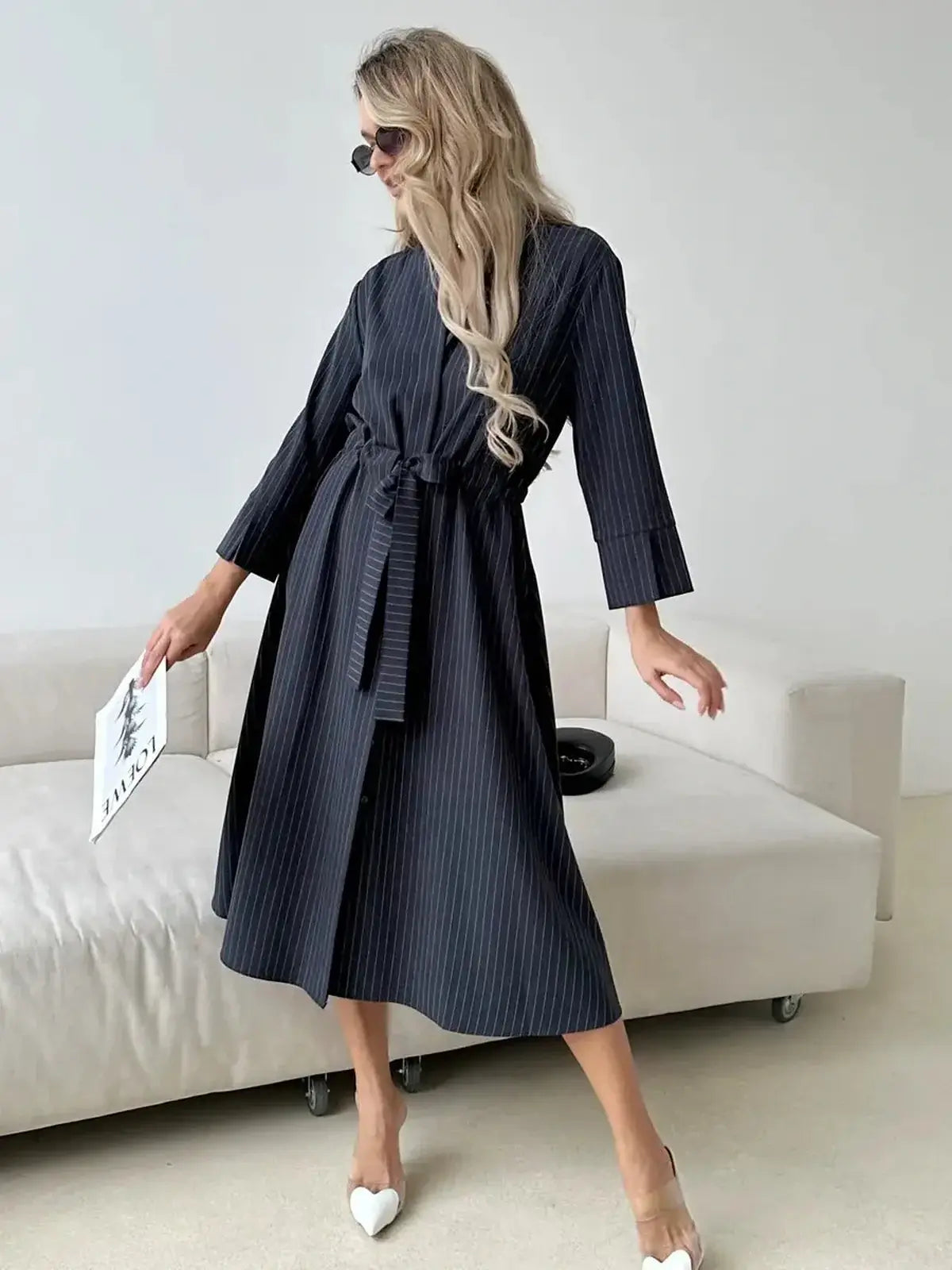 Slate Stripe Midi Dress featuring a relaxed fit, soft waist tie, and vertical pinstripes, perfect for versatile occasions.