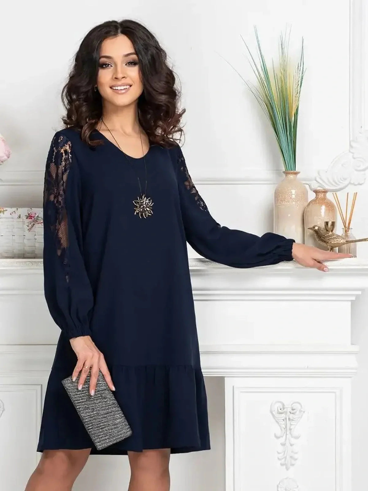 Model showcasing the Midnight Bloom mini dress in deep navy with lace accents, perfect for wedding guest or cocktail events.