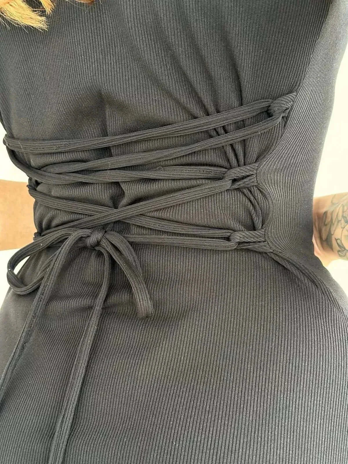 Close-up of the Slate Curve Mini Dress showing the modern lace-up detailing and soft ribbed stretch fabric.