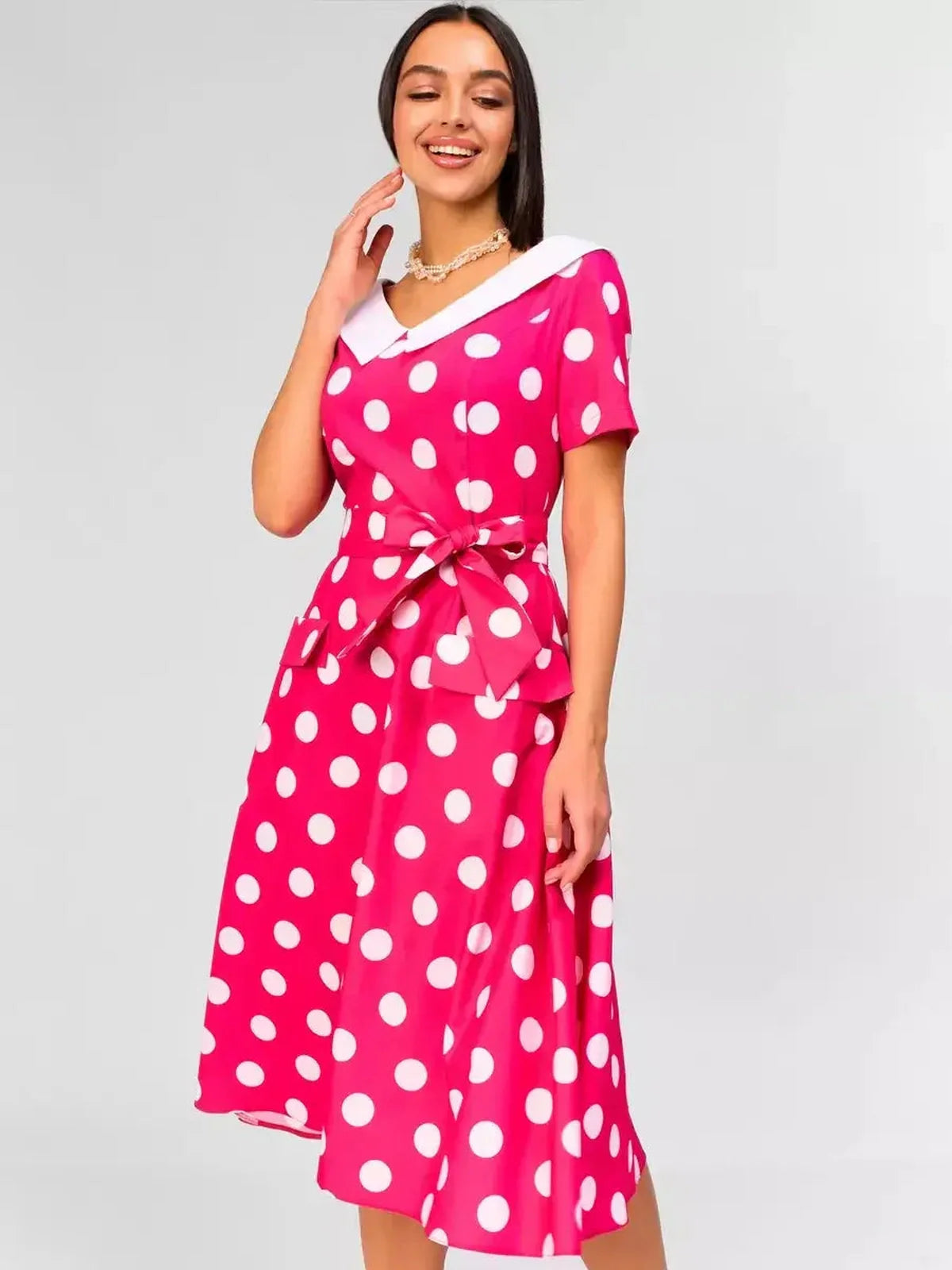 Monaco Charm Midi Dress in pink polka dot with white collar, perfect for weddings and summer events.