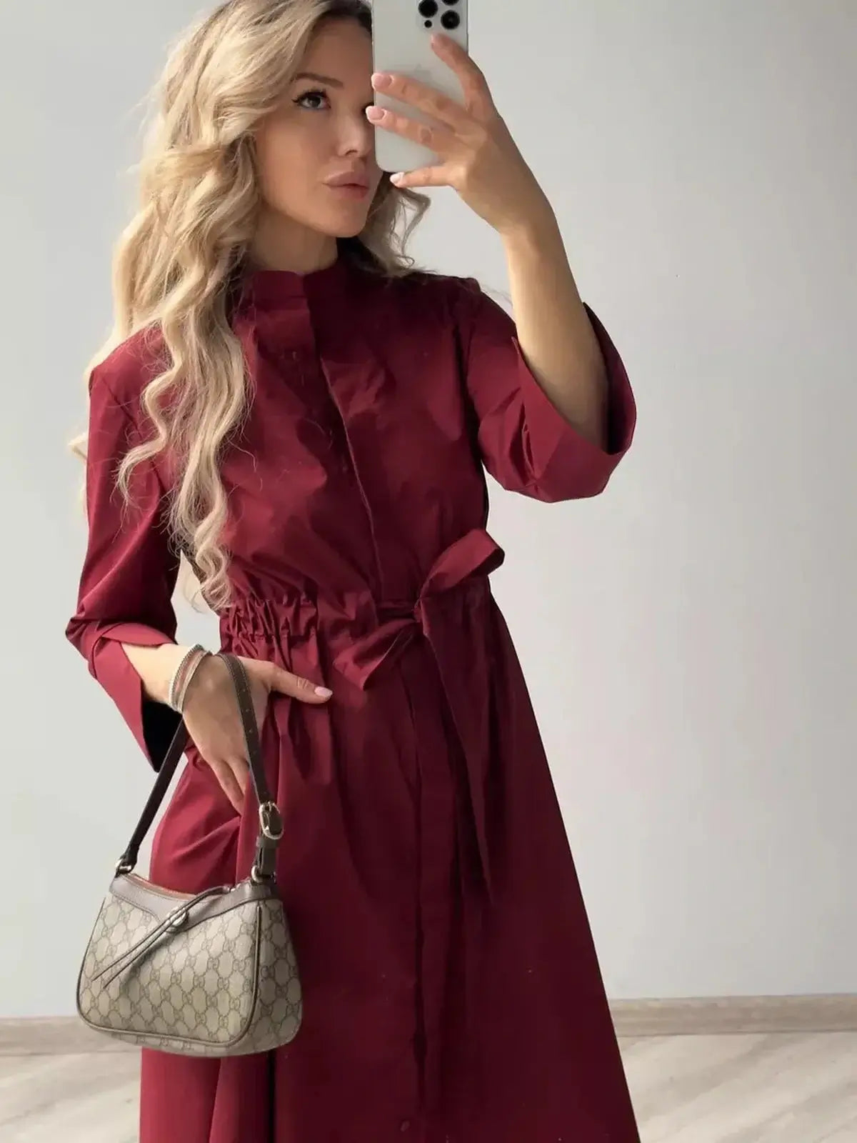 Burgundy Grace Midi Dress featuring a defined waist, elegant silhouette, and flowy design, perfect for weddings or formal events.