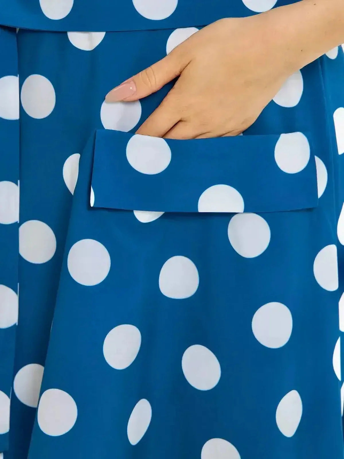 Close-up of Pearl Dot Midi Dress featuring large white polka dots and a patch pocket in a rich dark teal shade.
