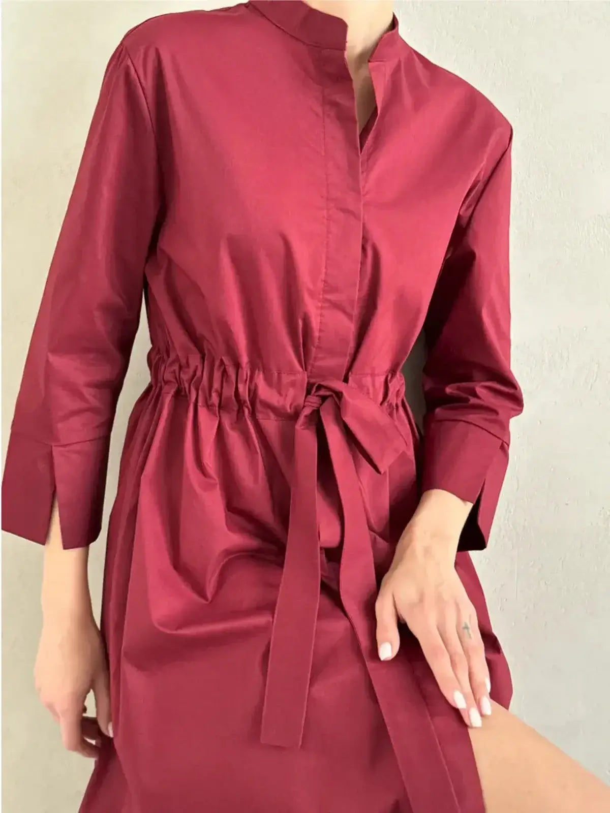 Burgundy Grace Midi Dress featuring a tie belt, elegant A-line silhouette, and tailored design for chic occasions.