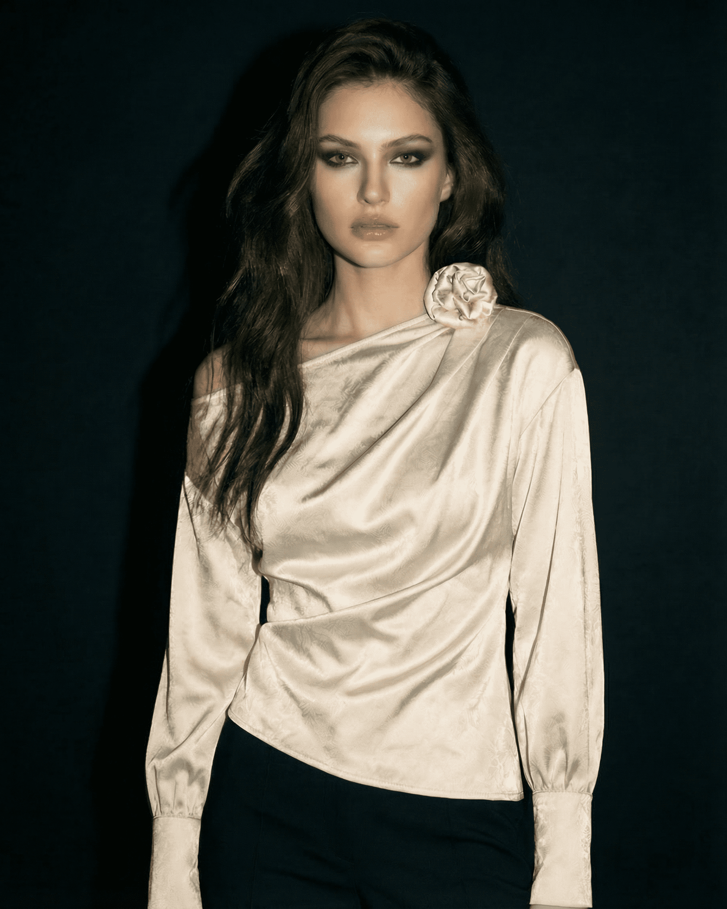 Ivory Blouse by Slimona, featuring an asymmetrical neckline and long sleeves in satin-style fabric.