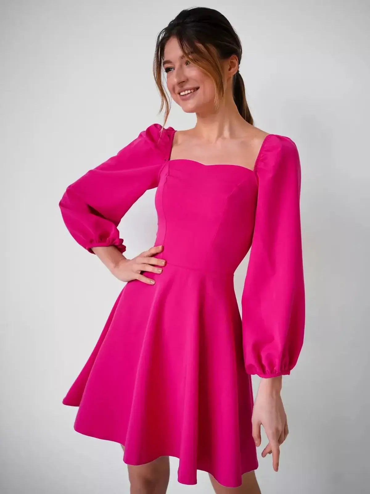 Fuchsia Bloom mini dress featuring a structured square neckline and long puff sleeves, ideal for summer occasions.