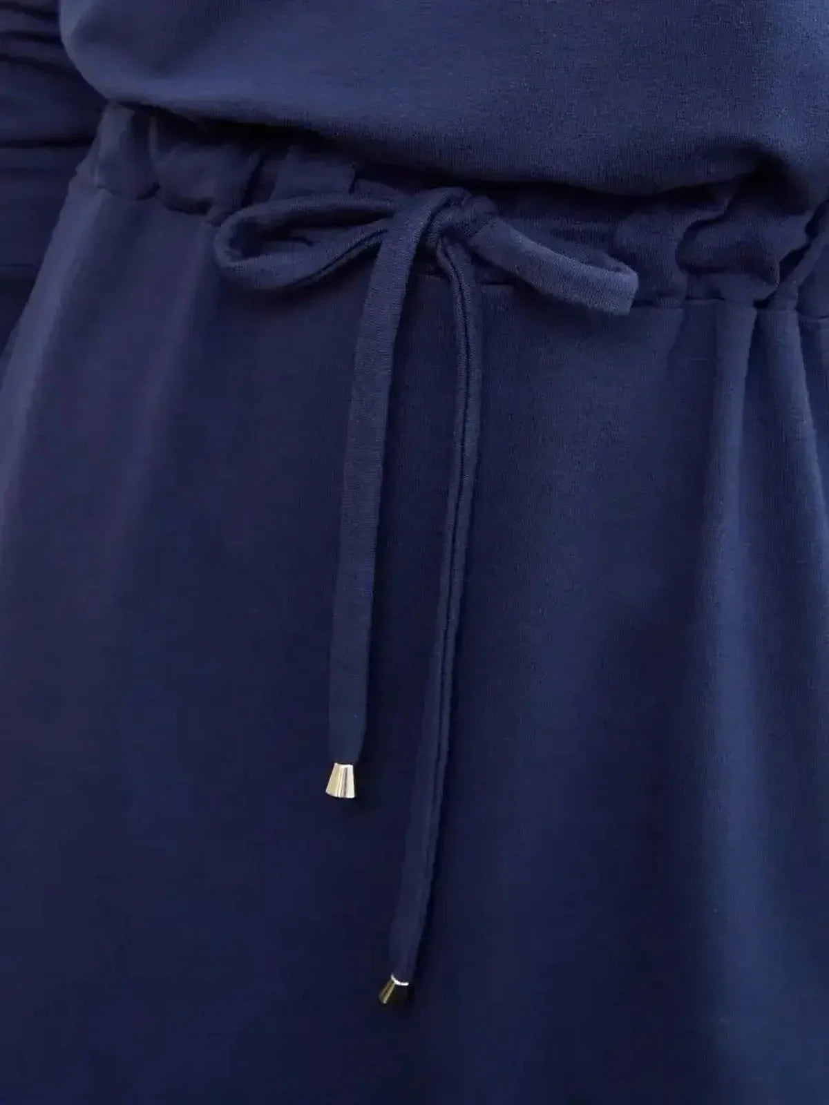 Close-up of the Celeste Maxi Dress waist tie detail in elegant navy fabric, ideal for summer dresses and wedding guest attire.