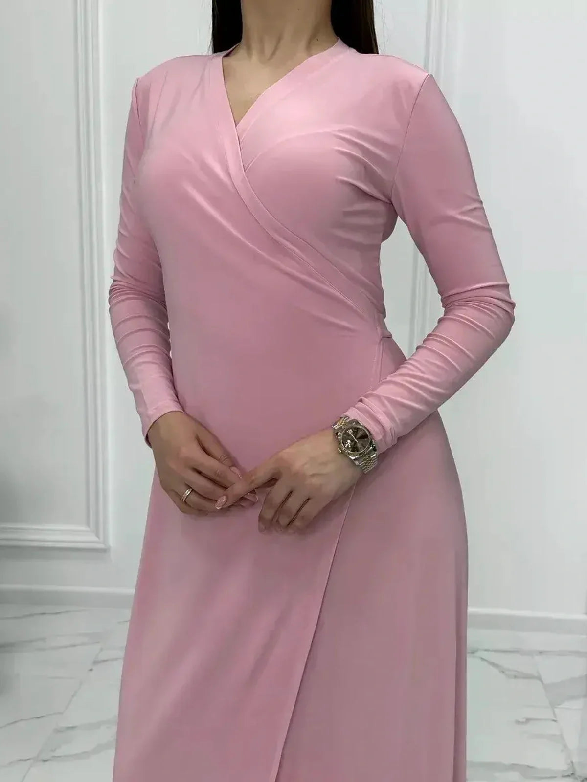 Eclipse Maxi Dress in soft powder pink featuring long sleeves and a flattering wrap silhouette, perfect for summer and formal occasions.