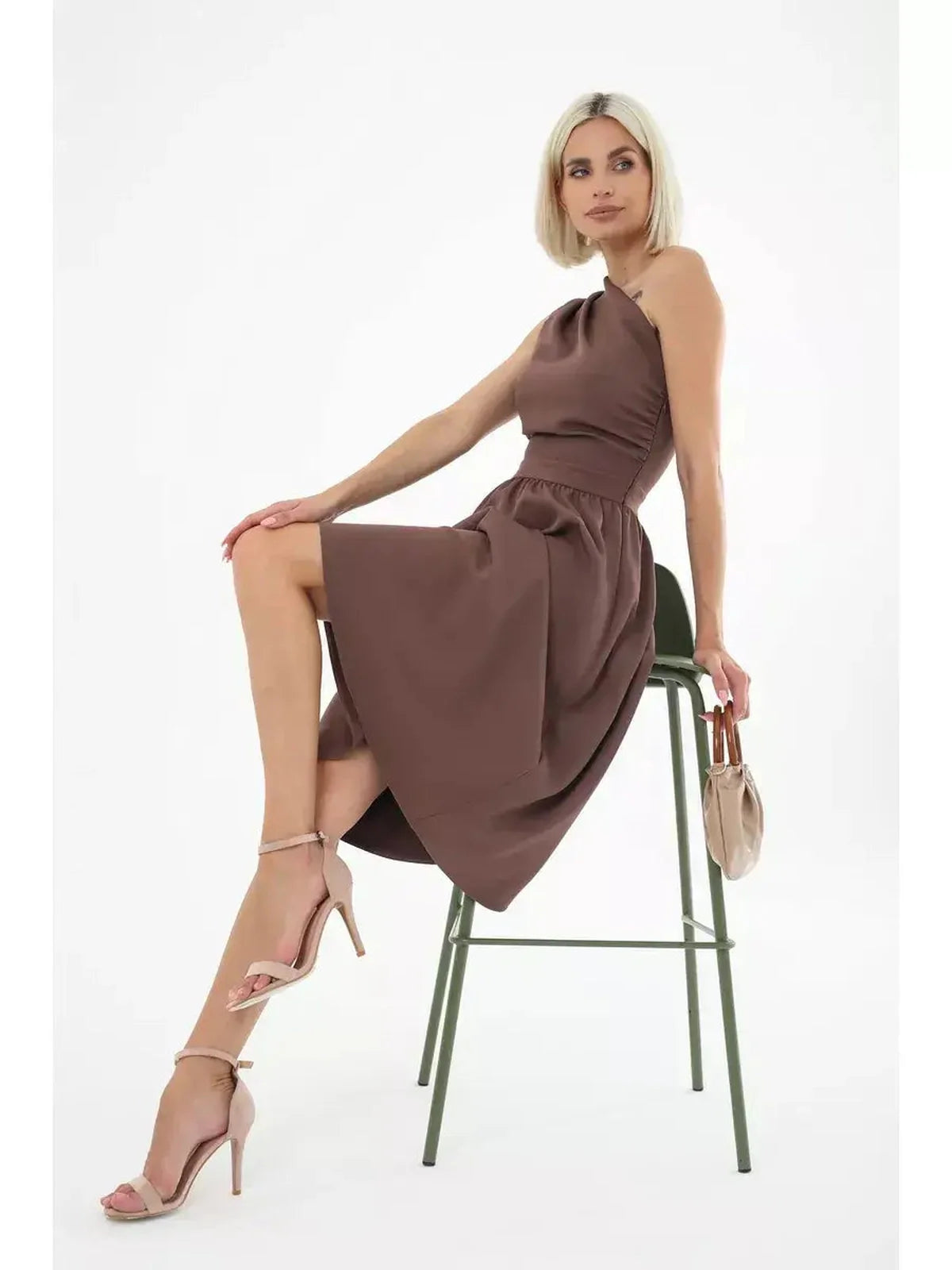 Woman in a chocolate brown midi dress with a one-shoulder neckline, ideal for weddings and summer parties.