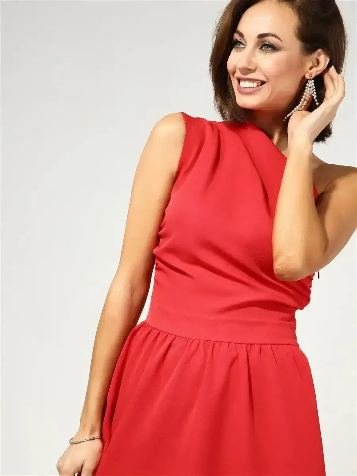 Model wearing the elegant Scarlet Sway Midi Dress in red, featuring a one-shoulder design and flared skirt.
