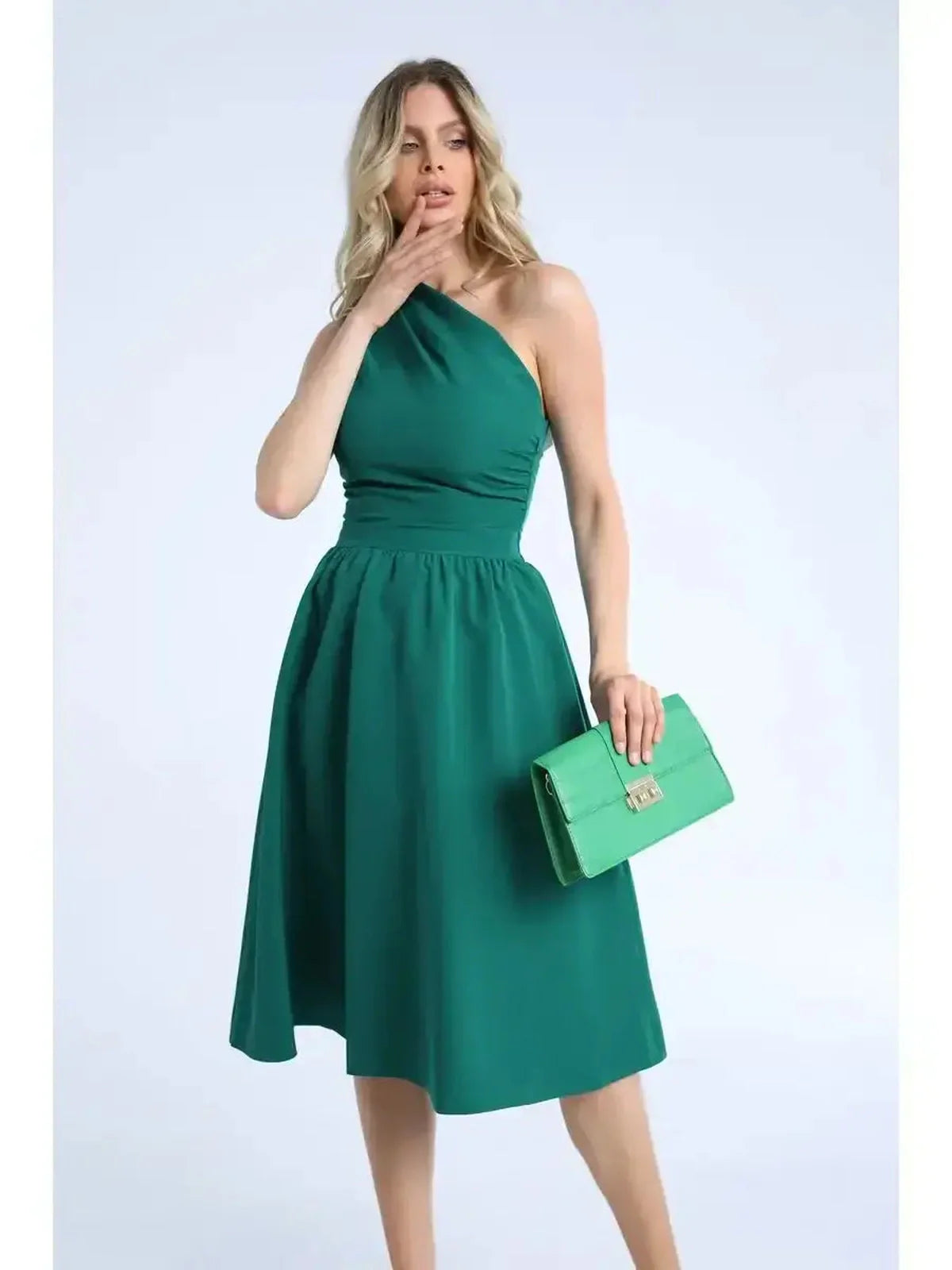 Emerald Grace Midi Dress featuring a one-shoulder design, ideal for weddings and special occasions, paired with a chic green clutch.