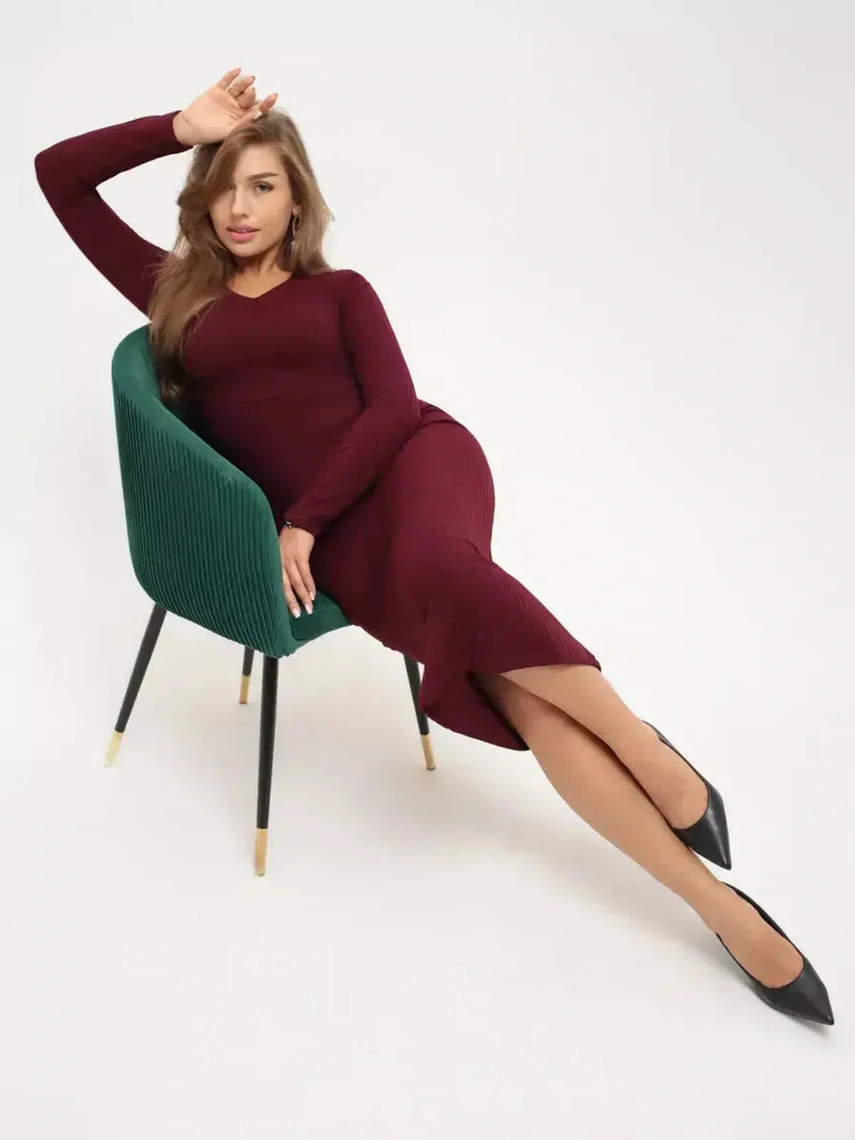 Model wearing a sleek Merlot Grace Midi Dress, showcasing its figure-hugging silhouette and elegant deep burgundy color.