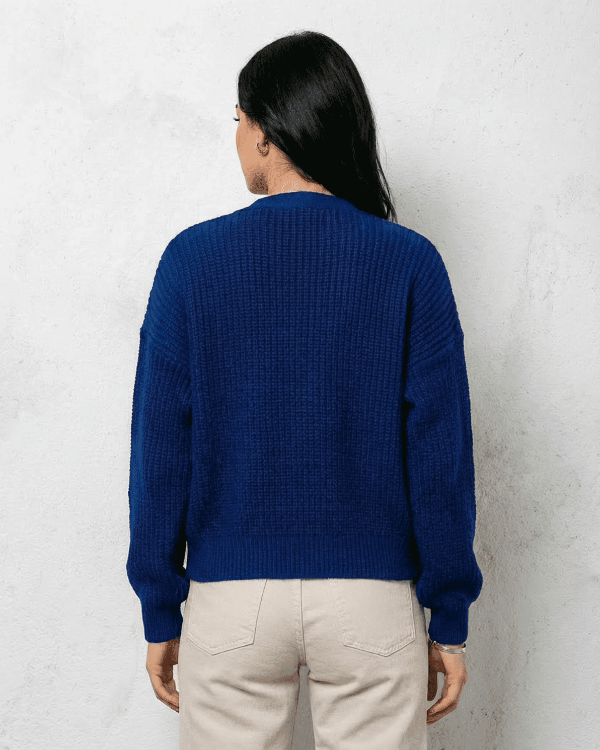 Back view of a woman wearing the Cobalt Cardigan from Slimona in a vibrant blue knit fabric.