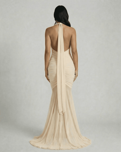 Elegant back view of the Slimona Champagne Maxi Dress with ruched design and flowing hem.