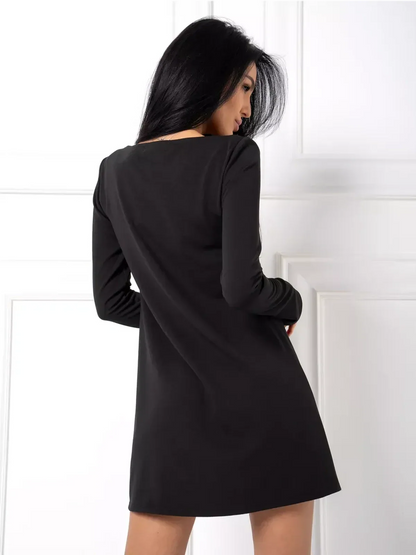 Back view of a sleek black mini dress featuring long sleeves and a smooth fabric, perfect for modern women’s fashion.