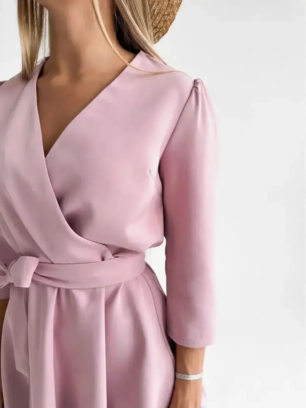 Elegant pink mini dress with a soft V-neckline and fitted waist, perfect for weddings and special occasions.