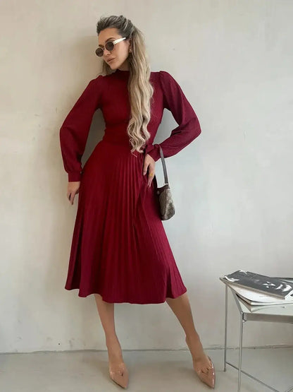 Model wearing a crimson midi dress with pleats, showcasing timeless elegance for formal occasions.
