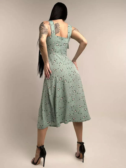 Flora Grace Midi Dress in pastel green floral print, showcasing a graceful A-line silhouette and elegant back design.
