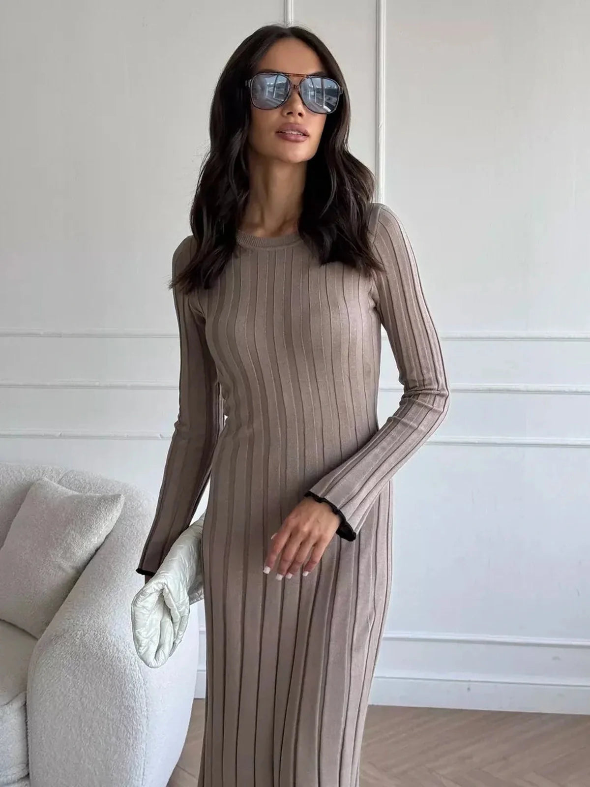Model in Contour Maxi Dress with ribbed knit texture and sunglasses, showcasing elegant full-length silhouette.