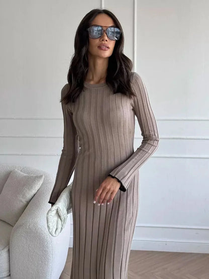 Model in Contour Maxi Dress with ribbed knit texture and sunglasses, showcasing elegant full-length silhouette.