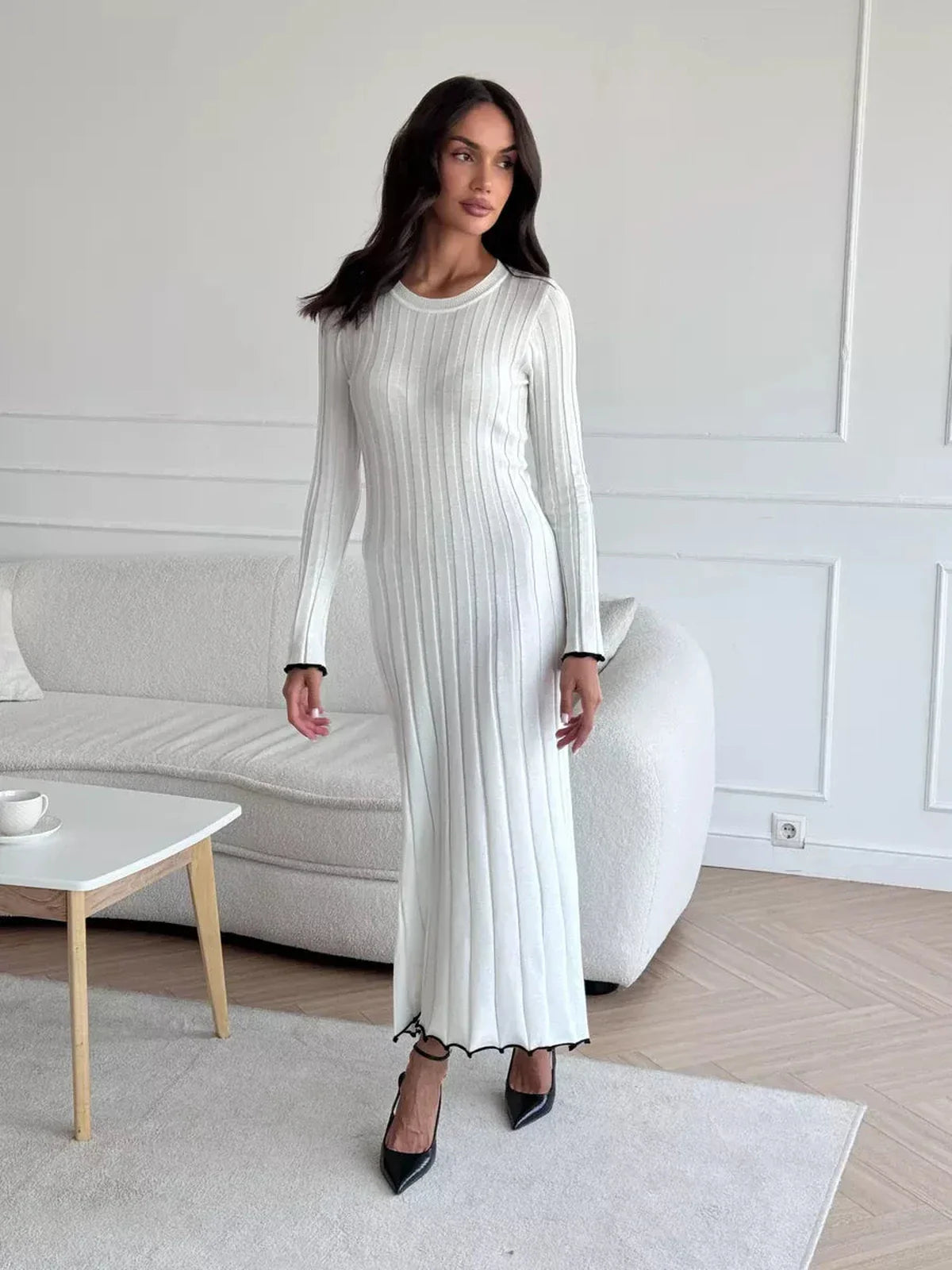 Model wearing the Ivory Grace Maxi Dress in white, showcasing its elegant ribbed texture and chic silhouette.