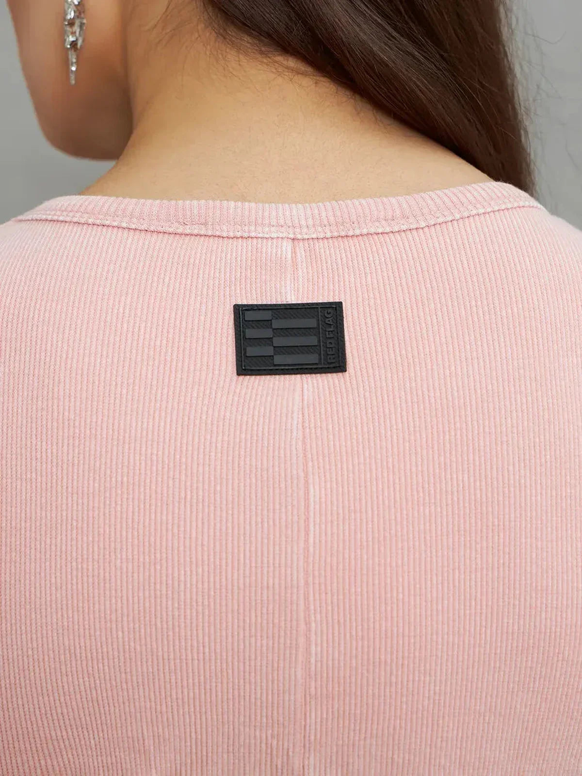 Close-up of the back neckline featuring a tag on the Rose Form Maxi Dress in soft dusty rose color.