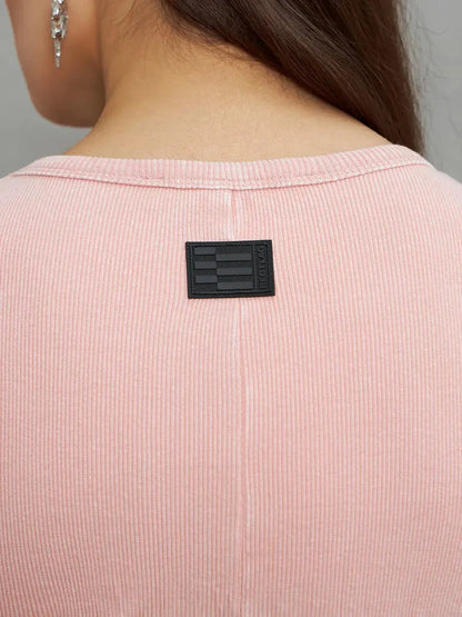 Close-up of the back neckline featuring a tag on the Rose Form Maxi Dress in soft dusty rose color.