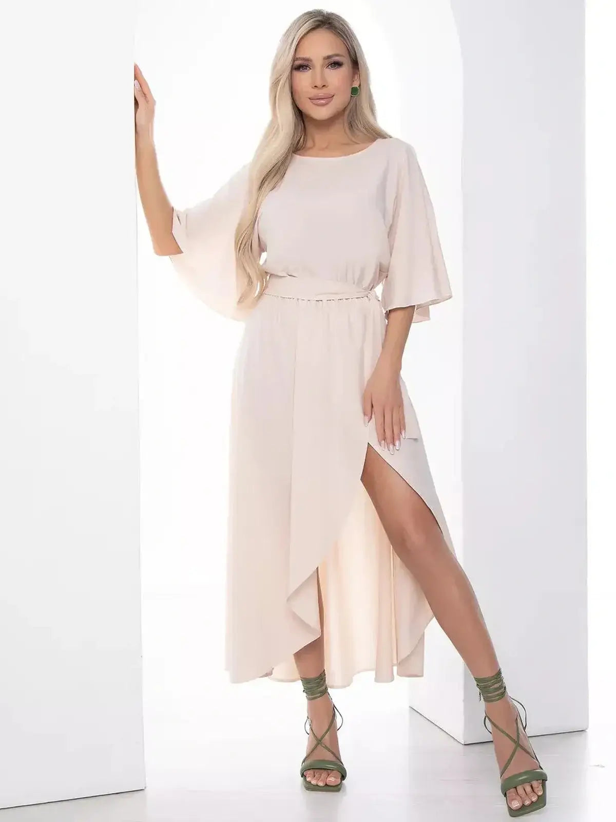 Woman wearing a Serenity Midi Dress with flared sleeves and side slit, styled for elegant occasions.