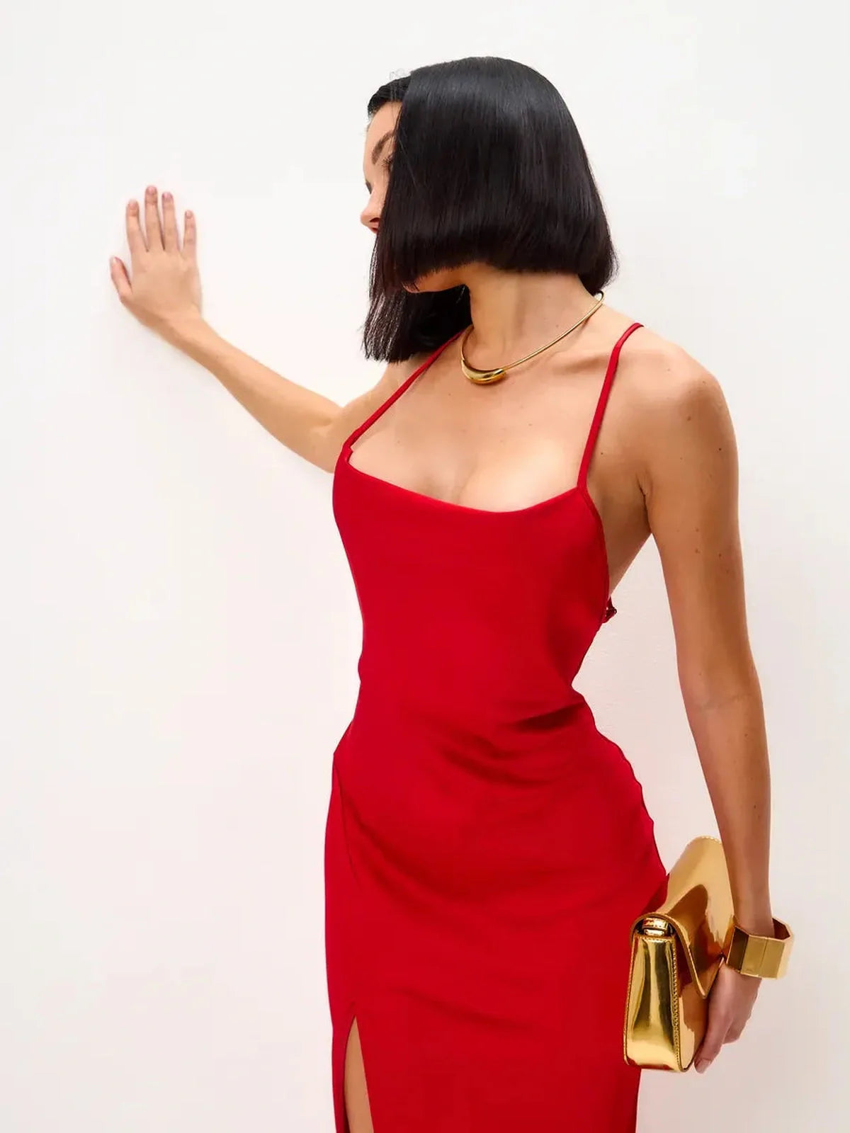 Scarlet Glow Midi Dress featuring a strappy silhouette, open back, and daring side slit, perfect for formal events.