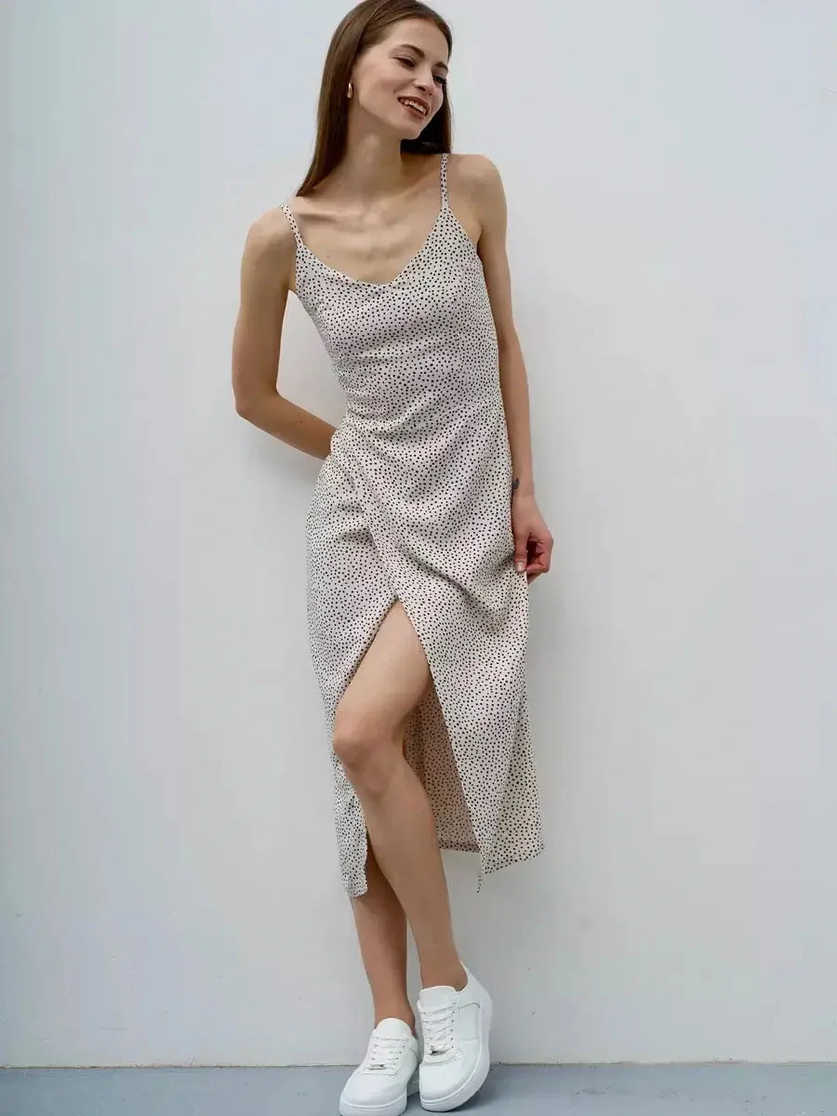 Model wearing a lightweight Dot Whisper Midi Dress with polka dots, perfect for summer, weddings, and casual outings.
