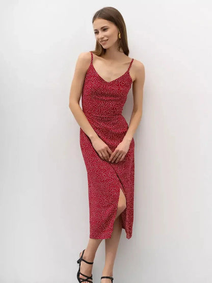 Cherry Dots Midi Dress in red with white polka dots, featuring a flattering wrap design and stylish slit, ideal for summer occasions.