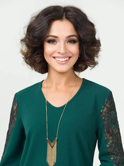 Elegant woman smiling in a green dress with lace detailing, showcasing stylish women's fashion.