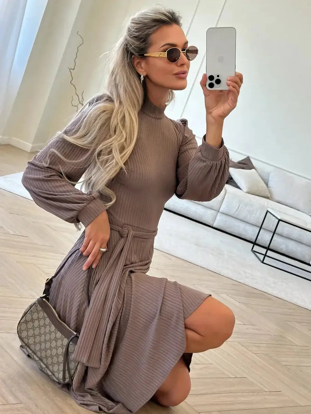 Woman in a stylish ribbed midi dress, showcasing modern elegance with a flattering silhouette and chic accessories.