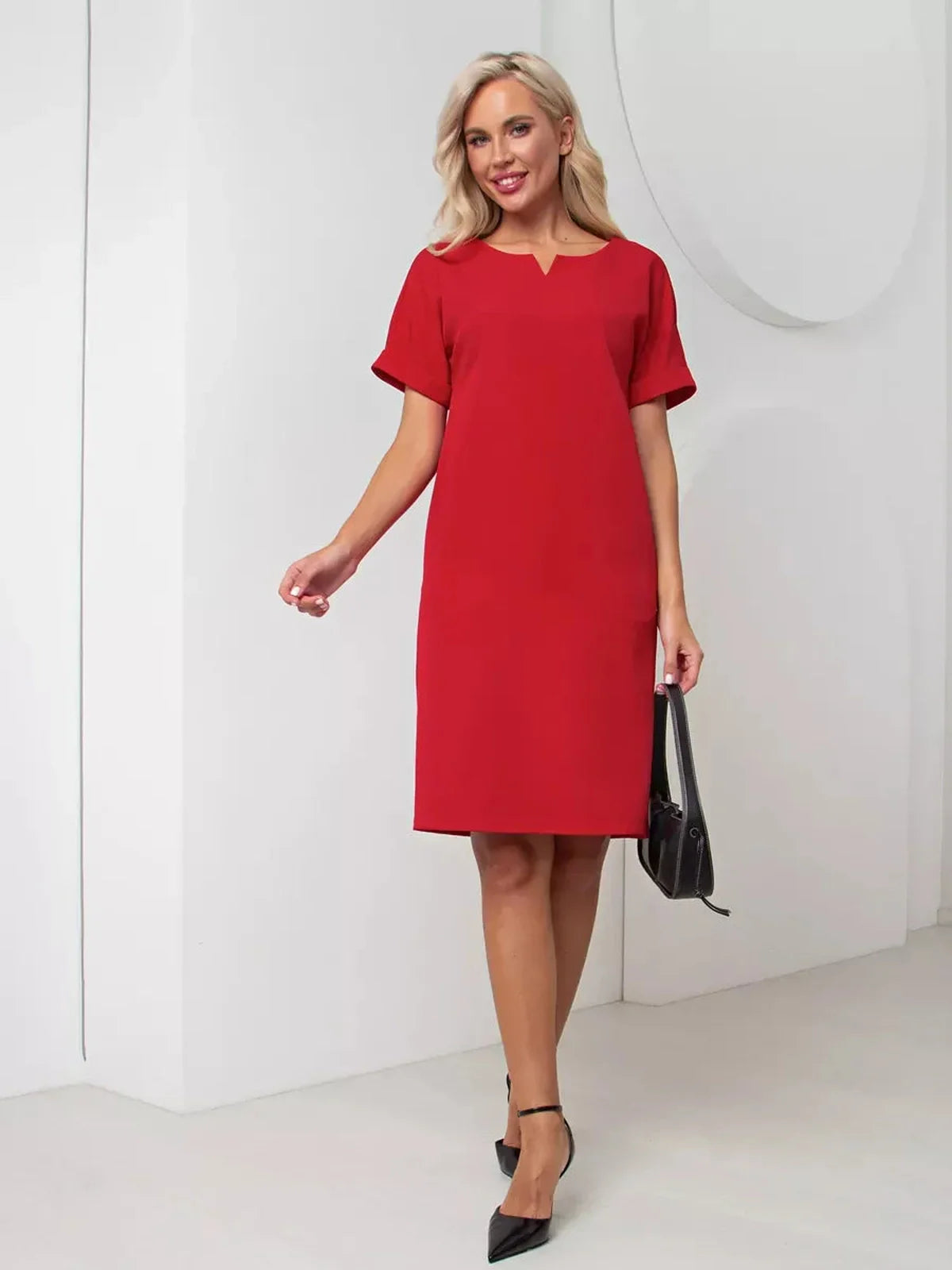 Stylish red mini dress with a flattering silhouette and notch neckline, perfect for summer weddings or cocktail events.