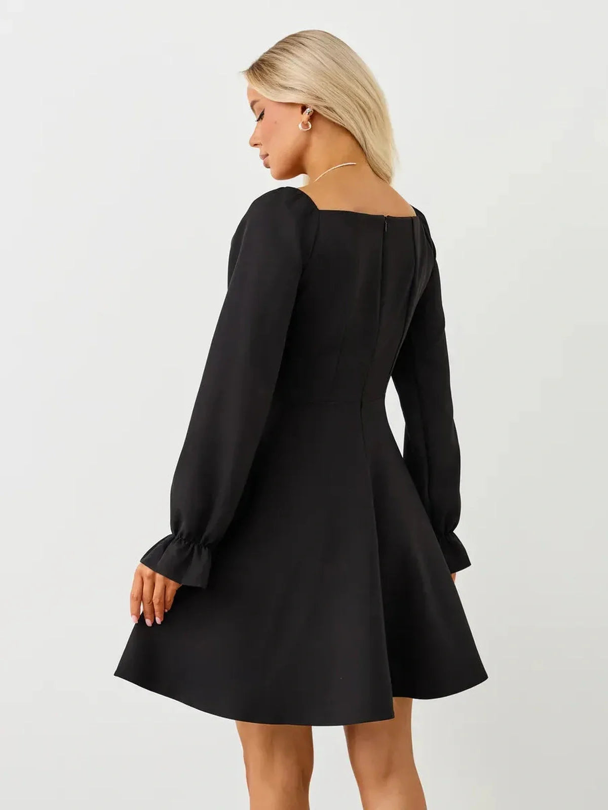 Elegant black velvet hour mini dress featuring a square neckline and voluminous long sleeves, perfect for special occasions.
